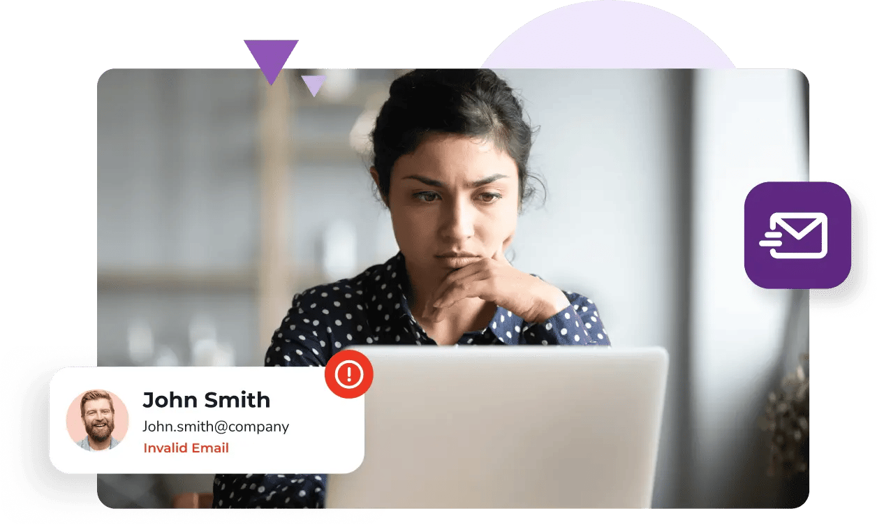 A woman in a polka-dot shirt looks at her laptop which shows that her contact John Smith has an invalid email address.