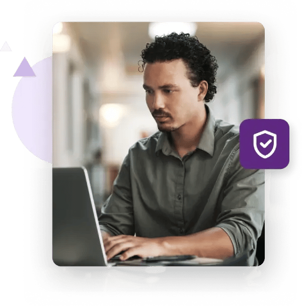 Businessman with rolled-up sleeves typing intently on his laptop along with a valid email icon