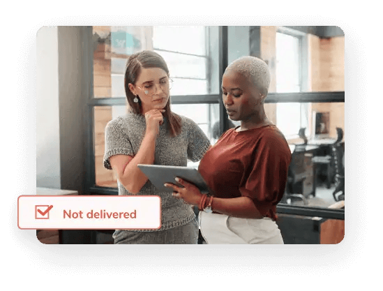 Two female colleagues look at a tablet displaying a report assessing average email list decay to promote email list retention.