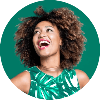 Woman in green looking up to her right and smiling at an email icon